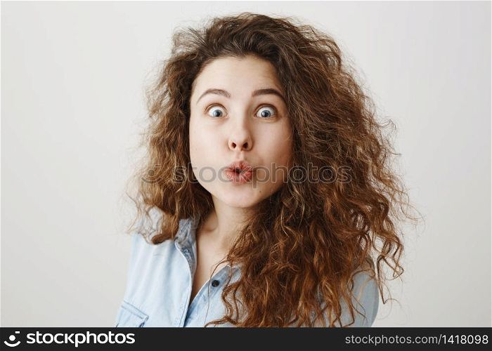 Portrait excited surprise young woman standing isolated over white background. Looking camera. Portrait excited surprise young woman standing isolated over white background. Looking camera.