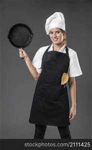 portrait female chef with pan