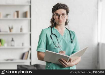 portrait female nurse holding book pen