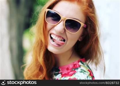 Portrait funny redhead girl with glasses. Photo toned style Instagram filters