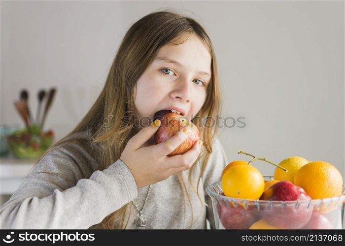 portrait girl eating red apple