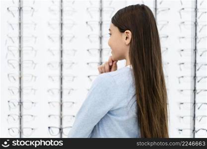 portrait girl eyeglasses store choosing pair 6. portrait girl eyeglasses store choosing pair 5