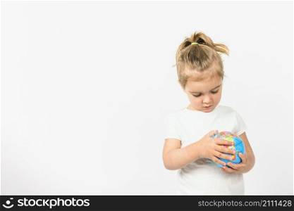 portrait girl holding globe ball against white background