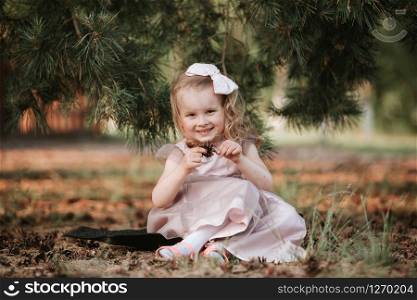 Portrait girl outdoors. Amazing little girl in a dress funny posing on nature background. cute girl walking in the woods. Portrait girl outdoors. cute girl walking in the woods. Amazing little girl in a dress funny posing on nature background.