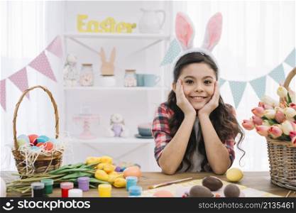 portrait girl with easter eggs paint tulips flowers table