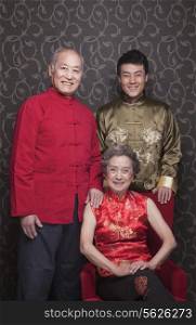 Portrait grandparents and grandson in traditional Chinese clothing