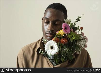 portrait handsome man posing with bouquet flowers