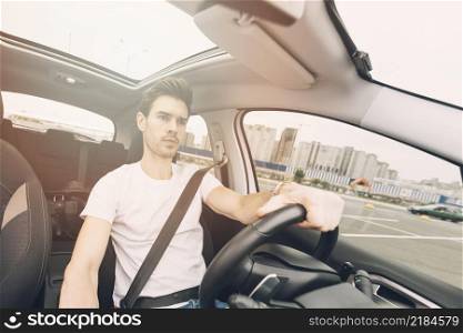 portrait handsome young man driving car