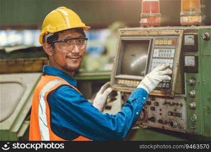 Portrait Happy Asian worker operate CNC machine in heavy steel industry factory. staff smiling with mechanical control panel.