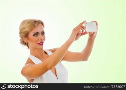 Portrait happy beautiful young woman taking selfie shot on color background
