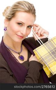 Portrait happy fashion woman in designer clothes with shopping bag