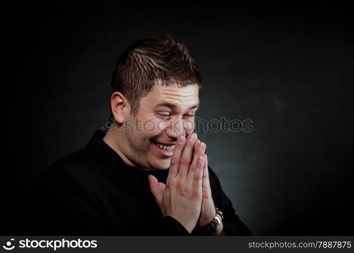 Portrait happy laughing man on black background