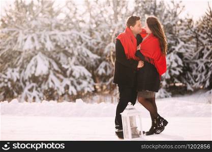 Portrait happy loving couple outdoors hugging and kissing, standing in winter forest park. Emotions of happiness. Concept of friendly family holiday. full length. Close Up. Love in Valentine&rsquo;s Day