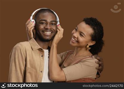 portrait happy smiley couple with headphones