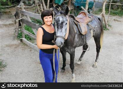 Portrait happy smiling woman with grey horse