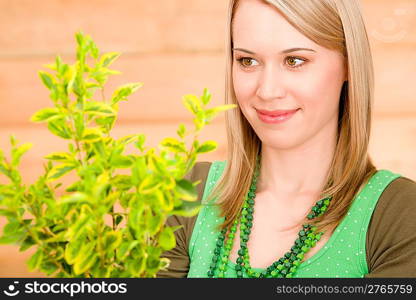 Portrait happy woman hold green plant spring gardening