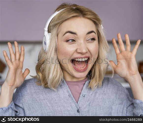 portrait happy woman laughing listening music headphones