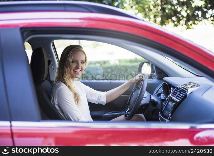 portrait happy woman sitting inside car
