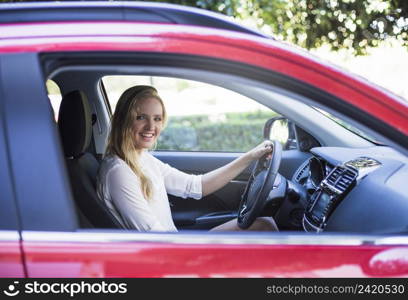portrait happy woman sitting inside car