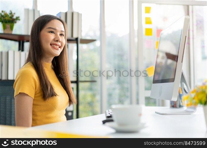 Portrait happy young programmer Asian woman work at start up technology office and using computer for coding application program and fully creative. Concept of smart entrepreneur woman working.