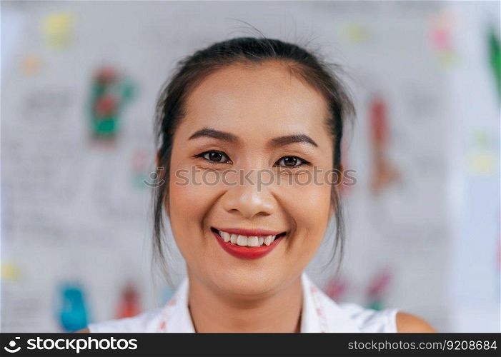 Portrait headshot of beautiful young fashion designer smile and looking to camera with happy in tailor shop
