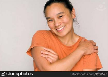 Portrait headshot of happy Asian woman smiling.