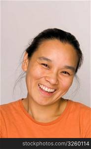 Portrait headshot of happy Asian woman smiling.