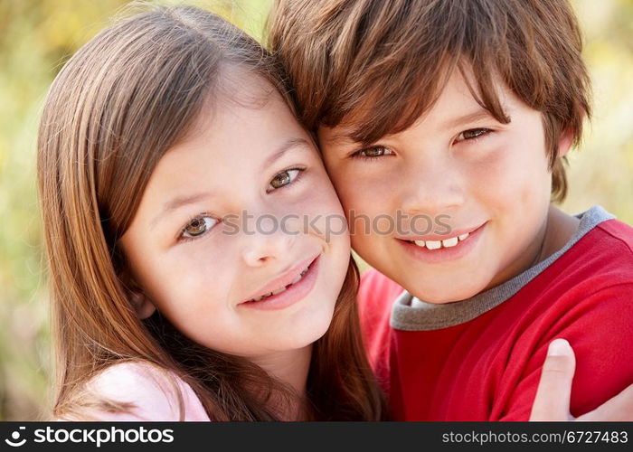 Portrait hispanic brother and sister outdoors