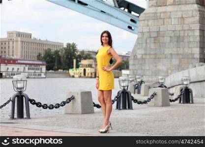 Portrait in full growth, attractive young woman in yellow dress &#xA;&#xA;