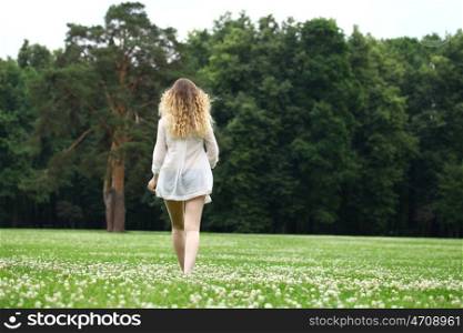 Portrait in full growth, Young beautiful blonde woman walking away