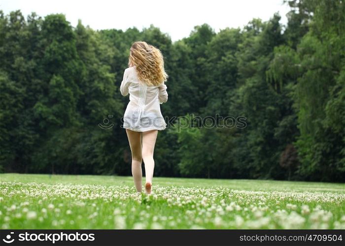 Portrait in full growth, Young beautiful blonde woman walking away