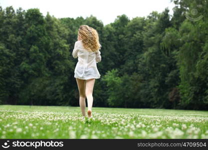 Portrait in full growth, Young beautiful blonde woman walking away