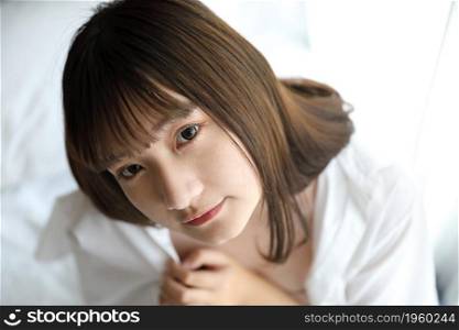 Portrait japanese school girl dressing school uniform in white tone bed room
