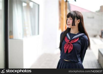 Portrait japanese school girl in downtown ice cream shop