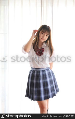 Portrait japanese school girl uniform in white tone bed room