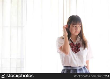 Portrait japanese school girl uniform in white tone bed room