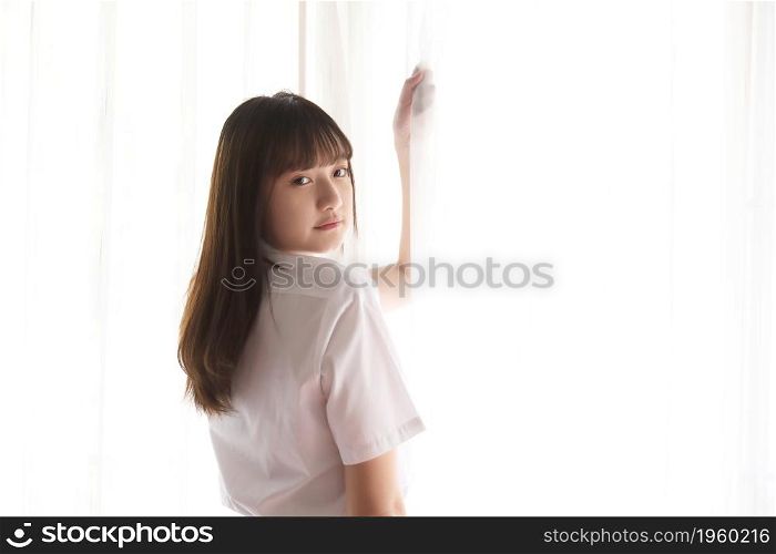 Portrait japanese school girl uniform in white tone bed room