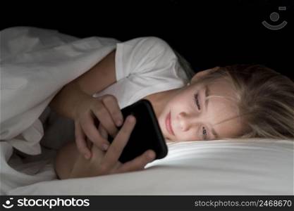 portrait little girl using phone night