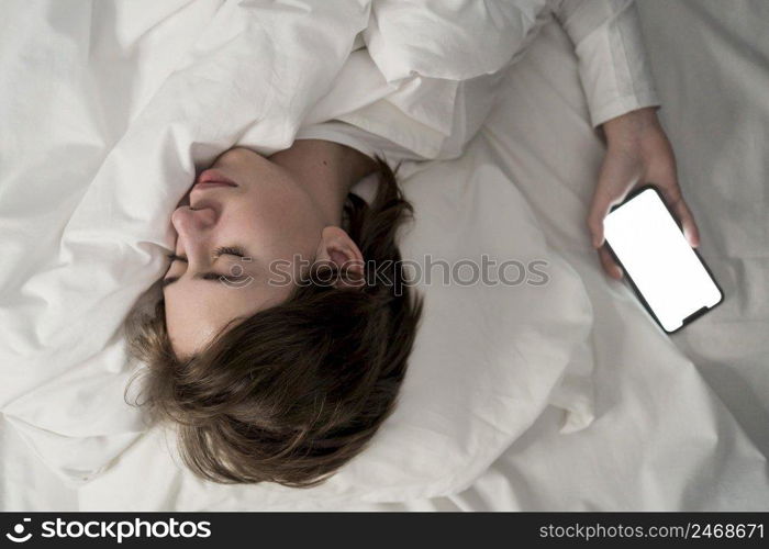 portrait little girl using phone while sleeping