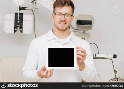 portrait male optometrist presenting tablet template