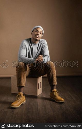 portrait male wearing cap sitting