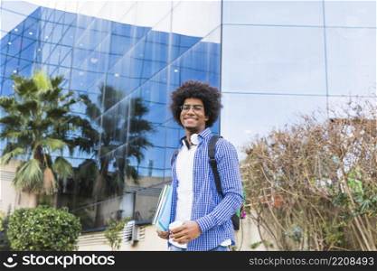 portrait male young student standing front university building