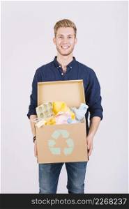 portrait man holding cardboard box full garbage with recycle icon