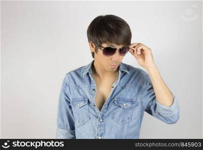 Portrait Man in Jeans Shirt Fashion Touching Eyeglasses. Jeans shirt or denim shirt fashion for men on grey background