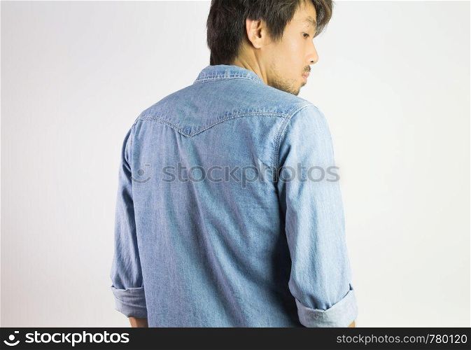 Portrait Man in Jeans Shirt or Denim Shirt Fashion in Back View. Jeans shirt or denim shirt fashion for men on grey background