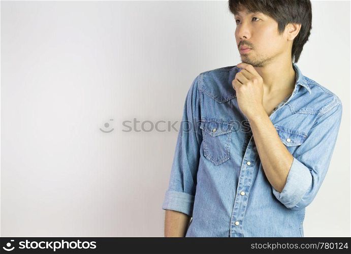 Portrait Man in Jeans Shirt or Denim Shirt Fashion Looking Above. Jeans shirt or denim shirt fashion for men on grey background