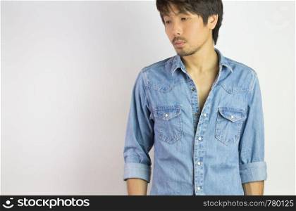 Portrait Man in Jeans Shirt or Denim Shirt Fashion Looking Below. Jeans shirt or denim shirt fashion for men on grey background