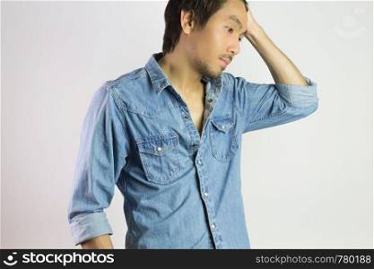 Portrait Man in Jeans Shirt or Denim Shirt Fashion Swing Hair Up Pose. Jeans shirt or denim shirt fashion for men on grey background