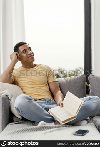 portrait man relaxing home reading