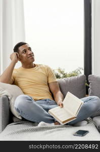 portrait man relaxing home reading